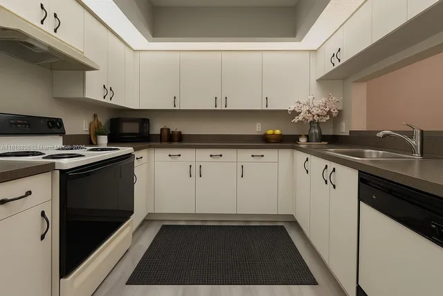a kitchen with granite countertop a sink stove and cabinets