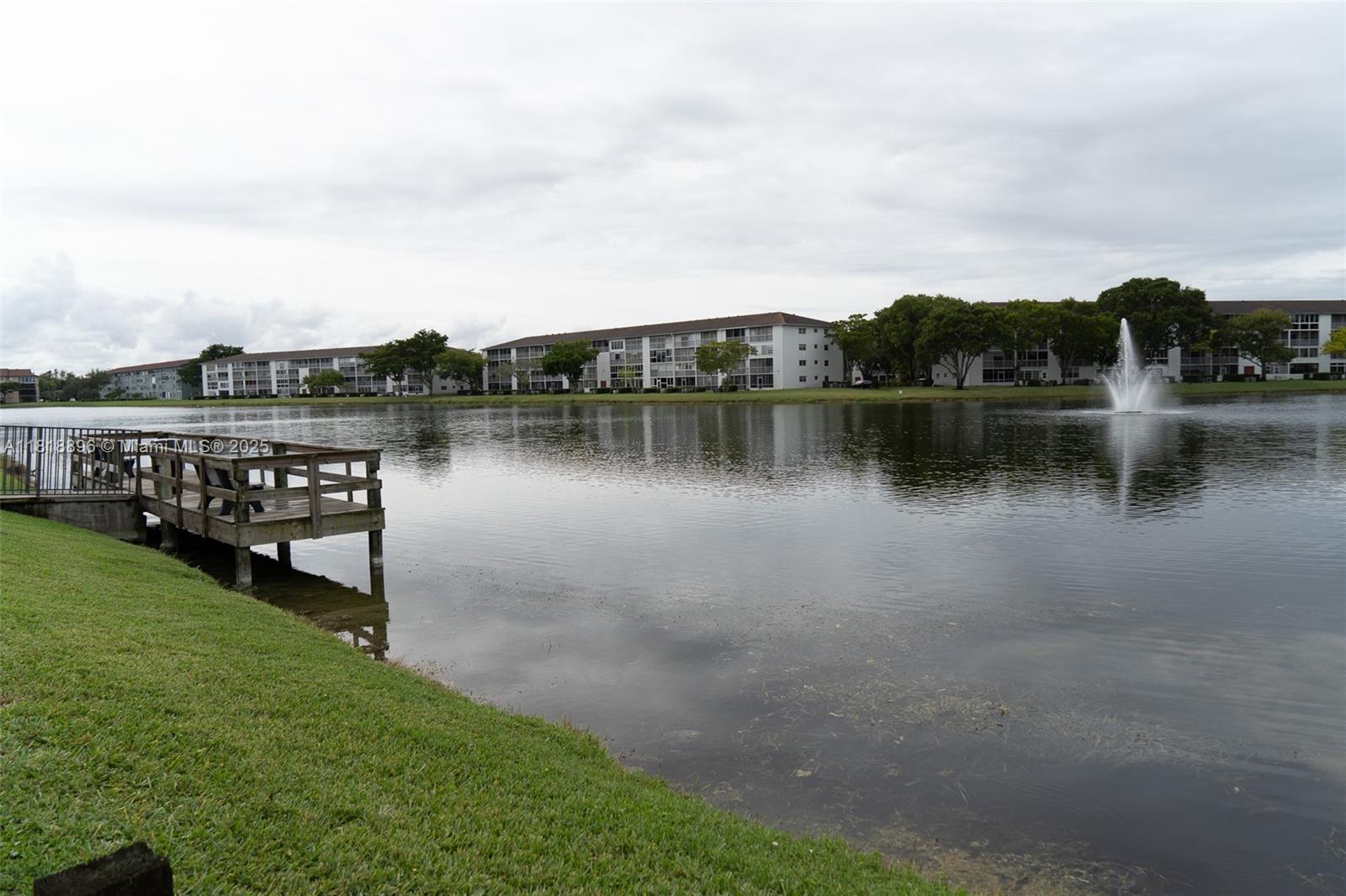 800 Southwest 142nd Avenue, Unit 211N Pembroke Pines, FL 33027 - Photo 26 of 28 a view of a lake with houses in the back