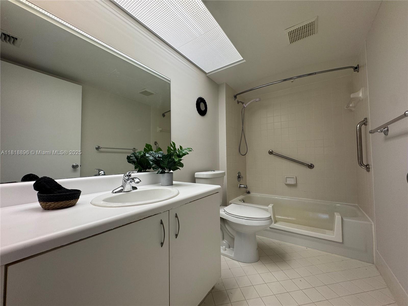 800 Southwest 142nd Avenue, Unit 211N Pembroke Pines, FL 33027 - Photo 8 of 28 a bathroom with a sink a toilet and shower