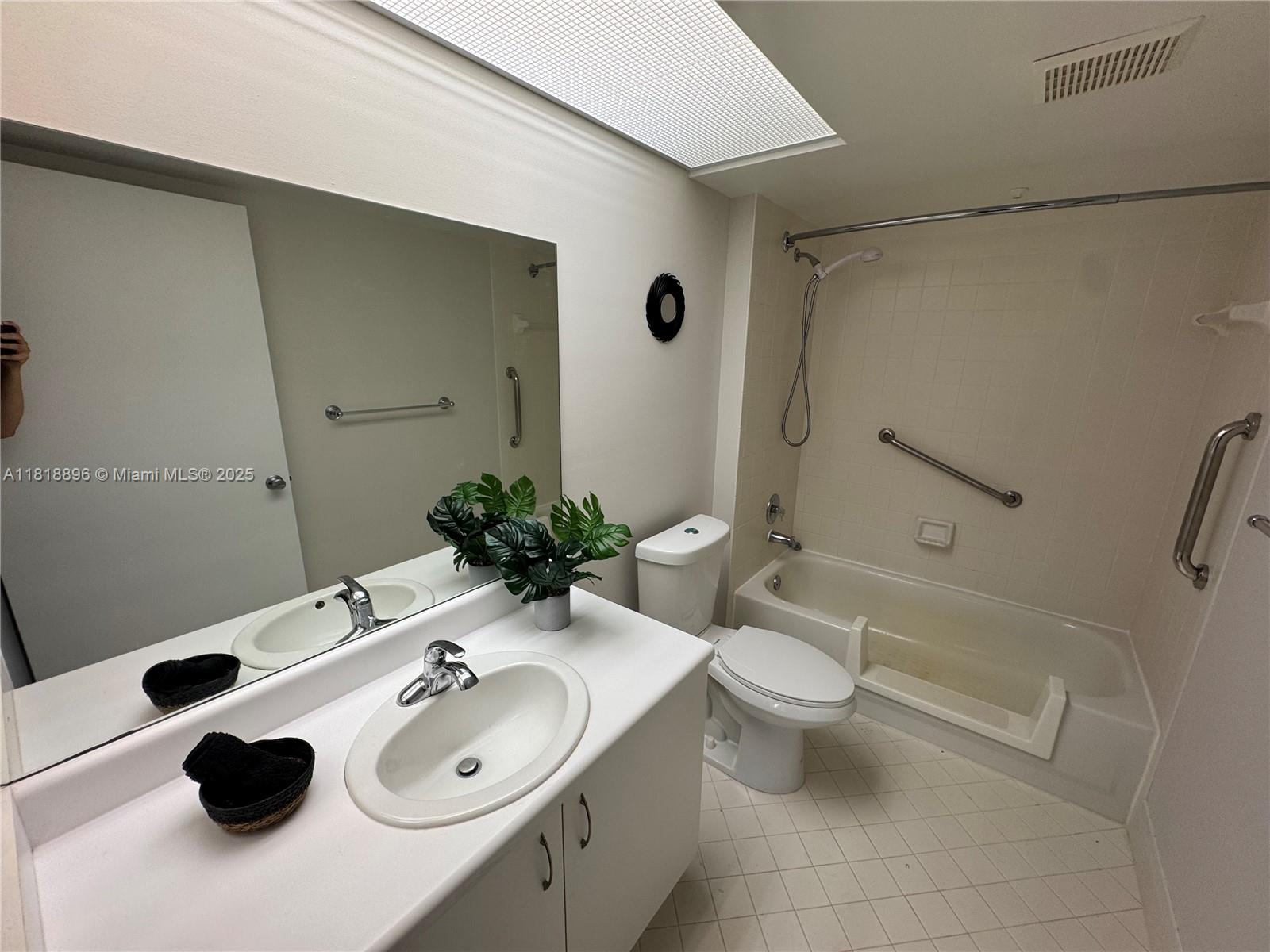 800 Southwest 142nd Avenue, Unit 211N Pembroke Pines, FL 33027 - Photo 9 of 28 a bathroom with a sink toilet and shower