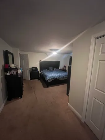 a view of an empty room and wooden floor