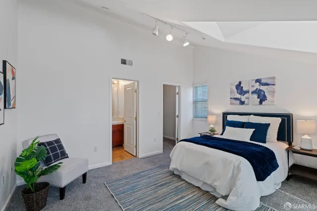 a bedroom with bed and a potted plant