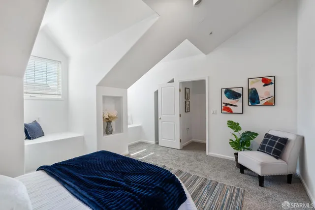 a bedroom with a bed and a couch