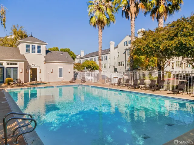 a swimming pool view with a outdoor seating