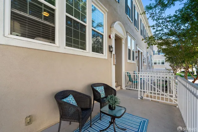 a balcony with table and chairs