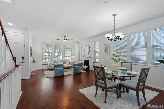 a view of a dining room with furniture wooden floor and chandelier