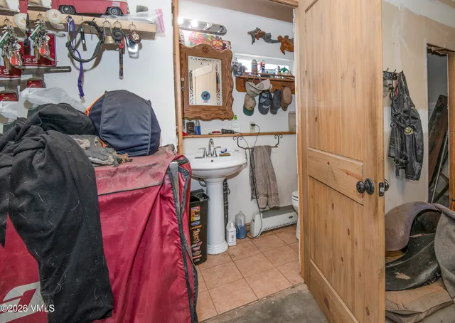 a bathroom with a sink and mirror with toilet
