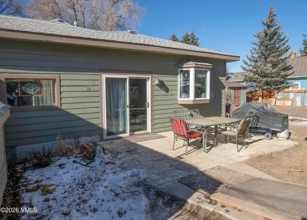 a front view of a house with a yard covered in snow