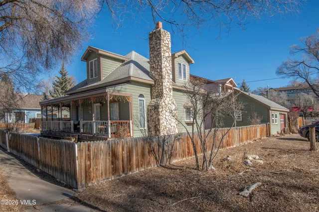 a view of a house with a yard and garage