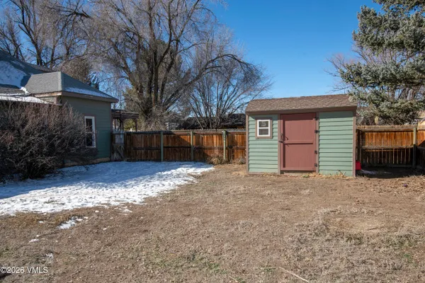 a front view of a house with a yard and seating space