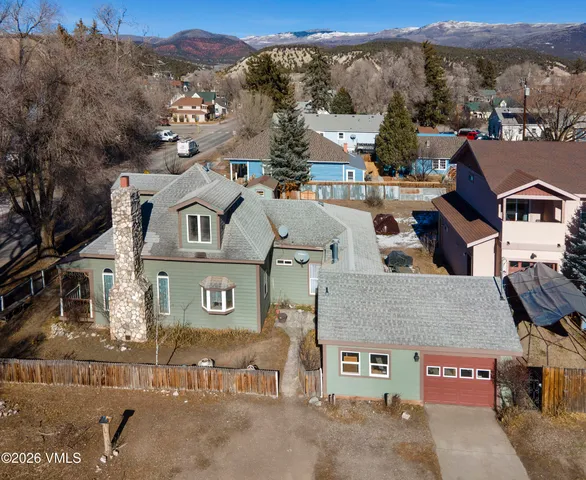 an aerial view of a house with a yard