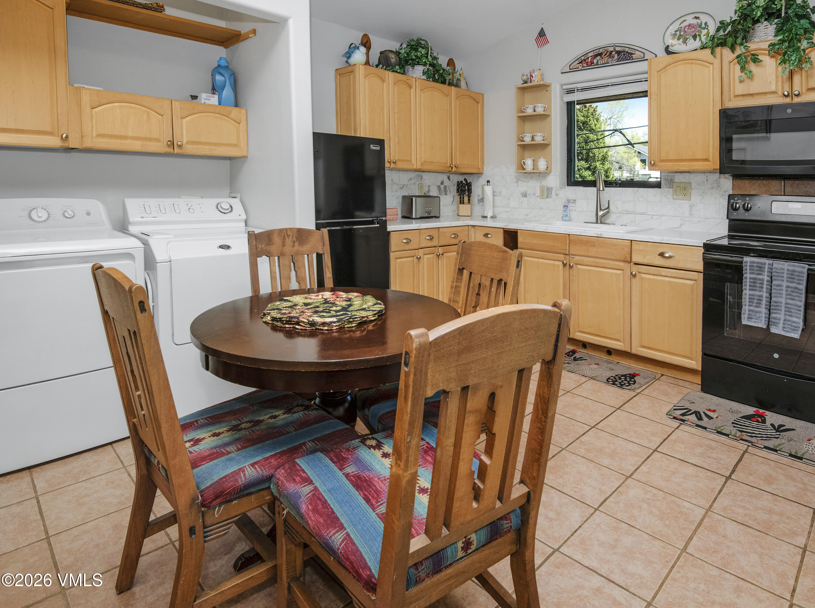 344 Capitol Street Eagle, CO 81631 - Photo 55 of 63 a view of a dining room with furniture and a kitchen