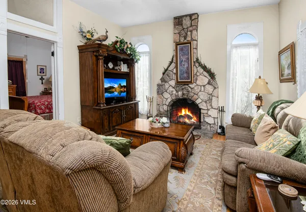 a living room with furniture and a fireplace