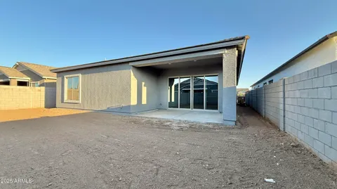 a large kitchen with stainless steel appliances a large counter top a sink and a refrigerator