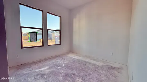 an empty room with windows and closet