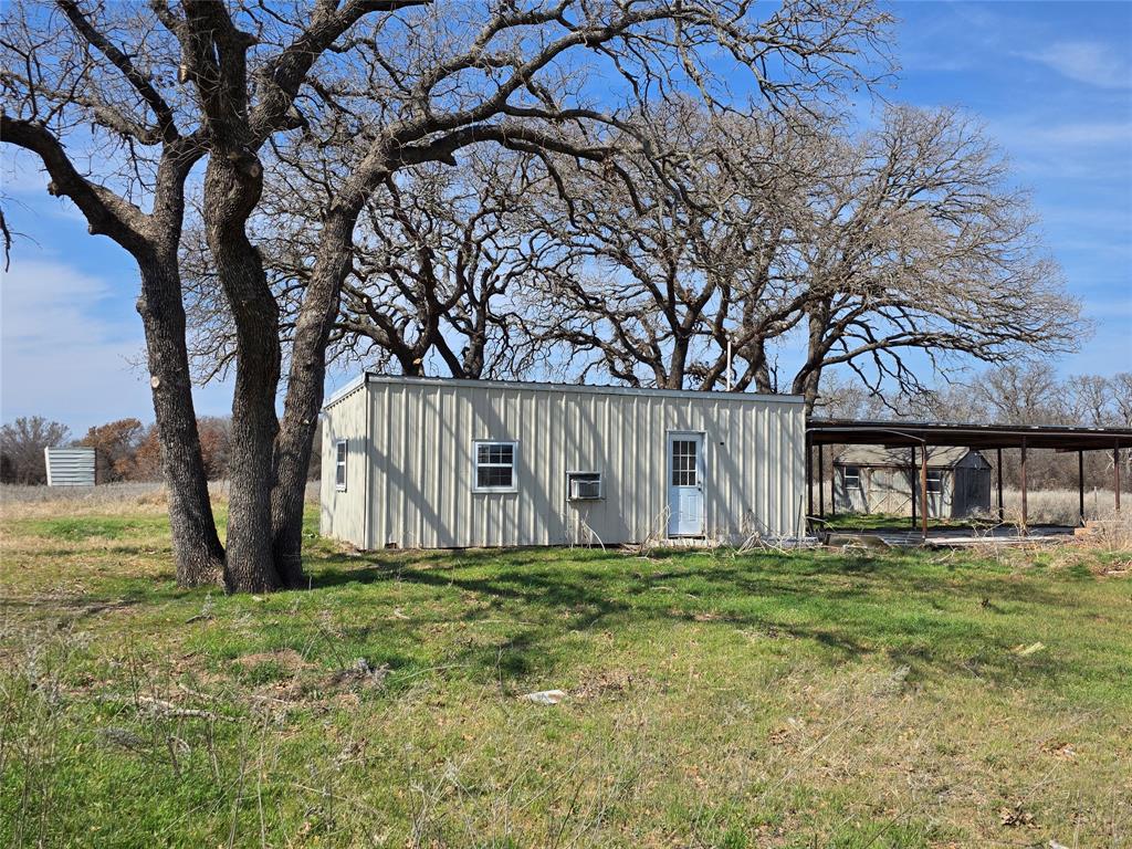 1000 County Road 375 Rising Star, TX 76471 - Photo 7 of 40 a white house with a tree in front of it