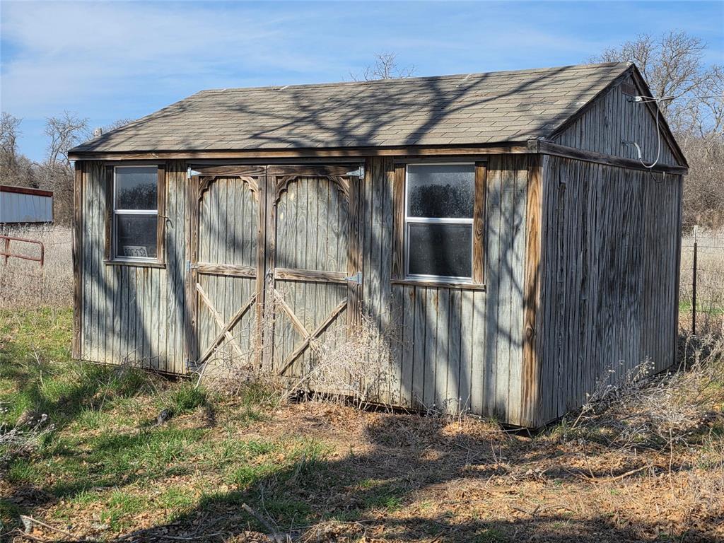 1000 County Road 375 Rising Star, TX 76471 - Photo 9 of 40 a black and white house with trees in the background