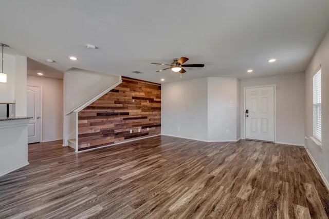 a view of empty room with wooden floor