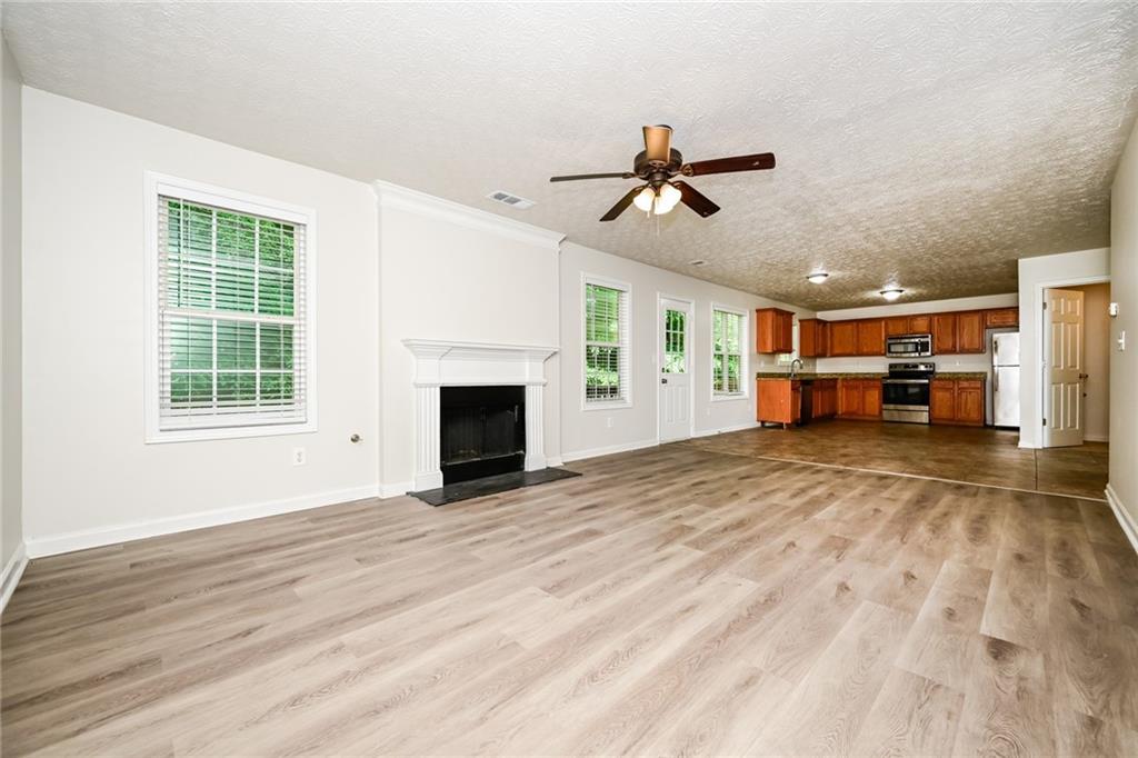 4468 Abram Way Conley, GA 30288 - Photo 3 of 23 a view of empty room with windows and fireplace