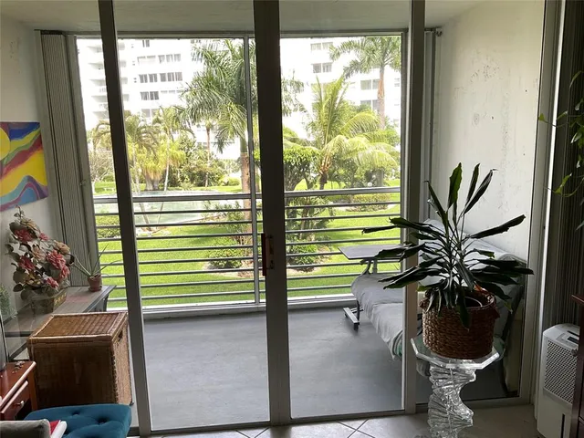 a dining room with furniture and a potted plant