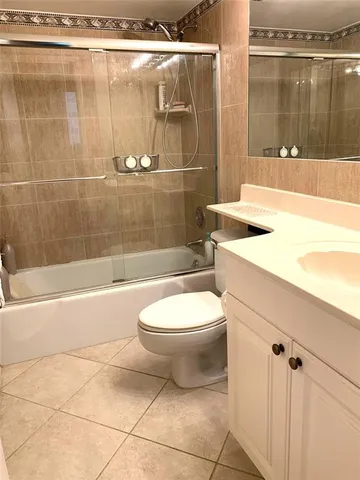 a bathroom with a toilet a sink and bathtub
