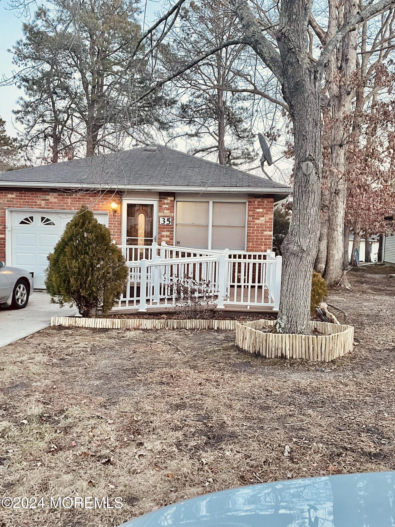35 Sycamore Access Road, Unit 12 Manahawkin, NJ 08050 - Photo 1 of 34 a front view of a house with a yard