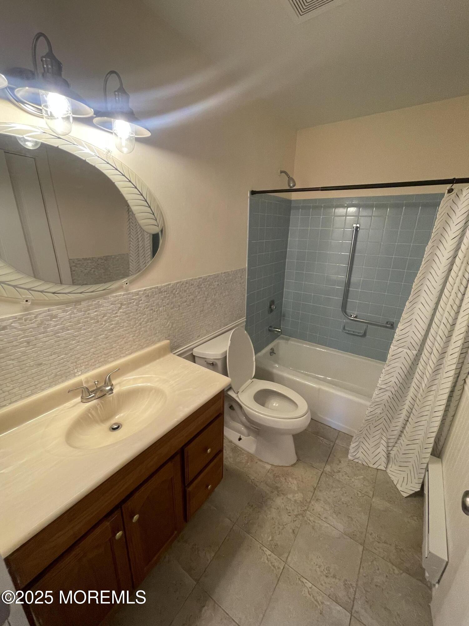 35 Sycamore Access Road, Unit 12 Manahawkin, NJ 08050 - Photo 12 of 34 a bathroom with a sink a toilet and shower