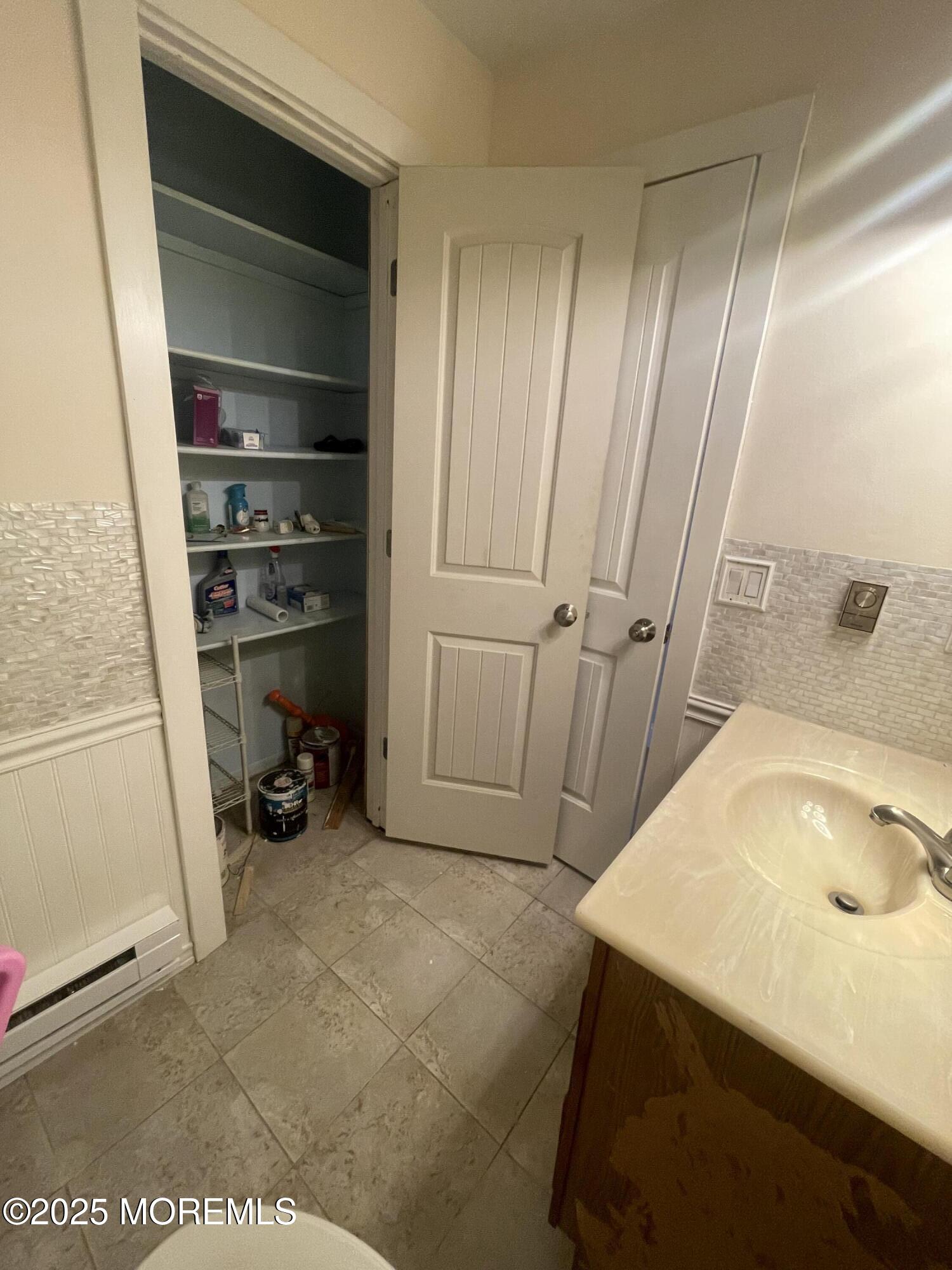 35 Sycamore Access Road, Unit 12 Manahawkin, NJ 08050 - Photo 13 of 34 a bathroom with a sink and a tub