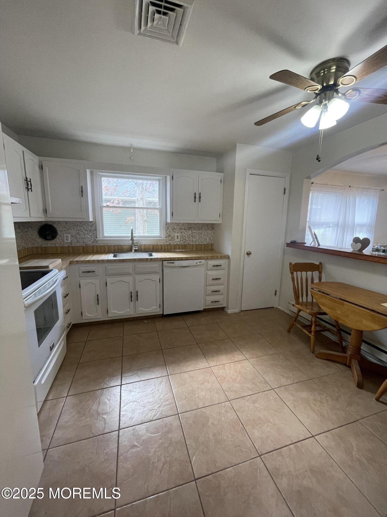 35 Sycamore Access Road, Unit 12 Manahawkin, NJ 08050 - Photo 15 of 34 a kitchen with a cabinets and appliances