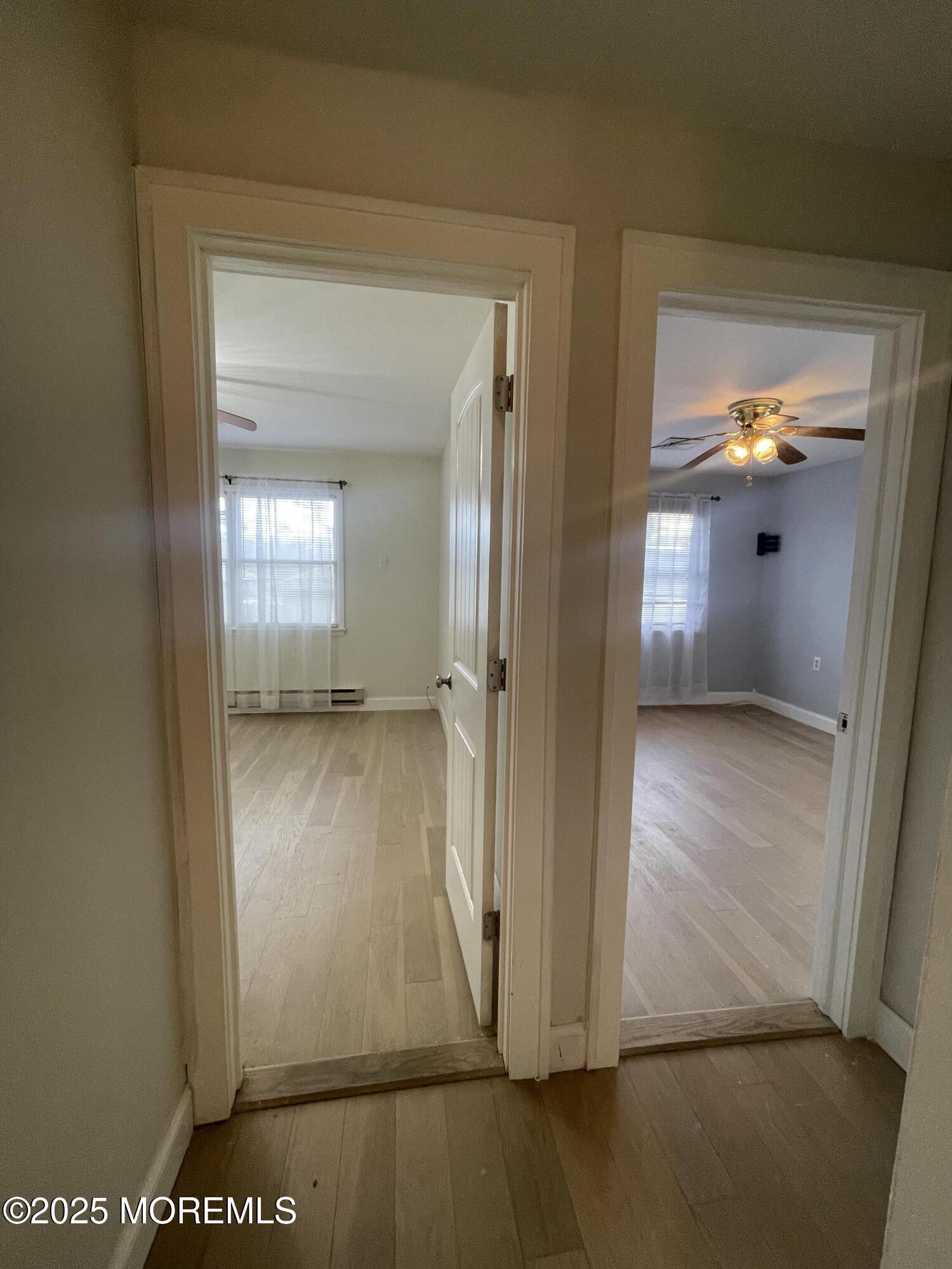 35 Sycamore Access Road, Unit 12 Manahawkin, NJ 08050 - Photo 18 of 34 an empty room with wooden floor and windows