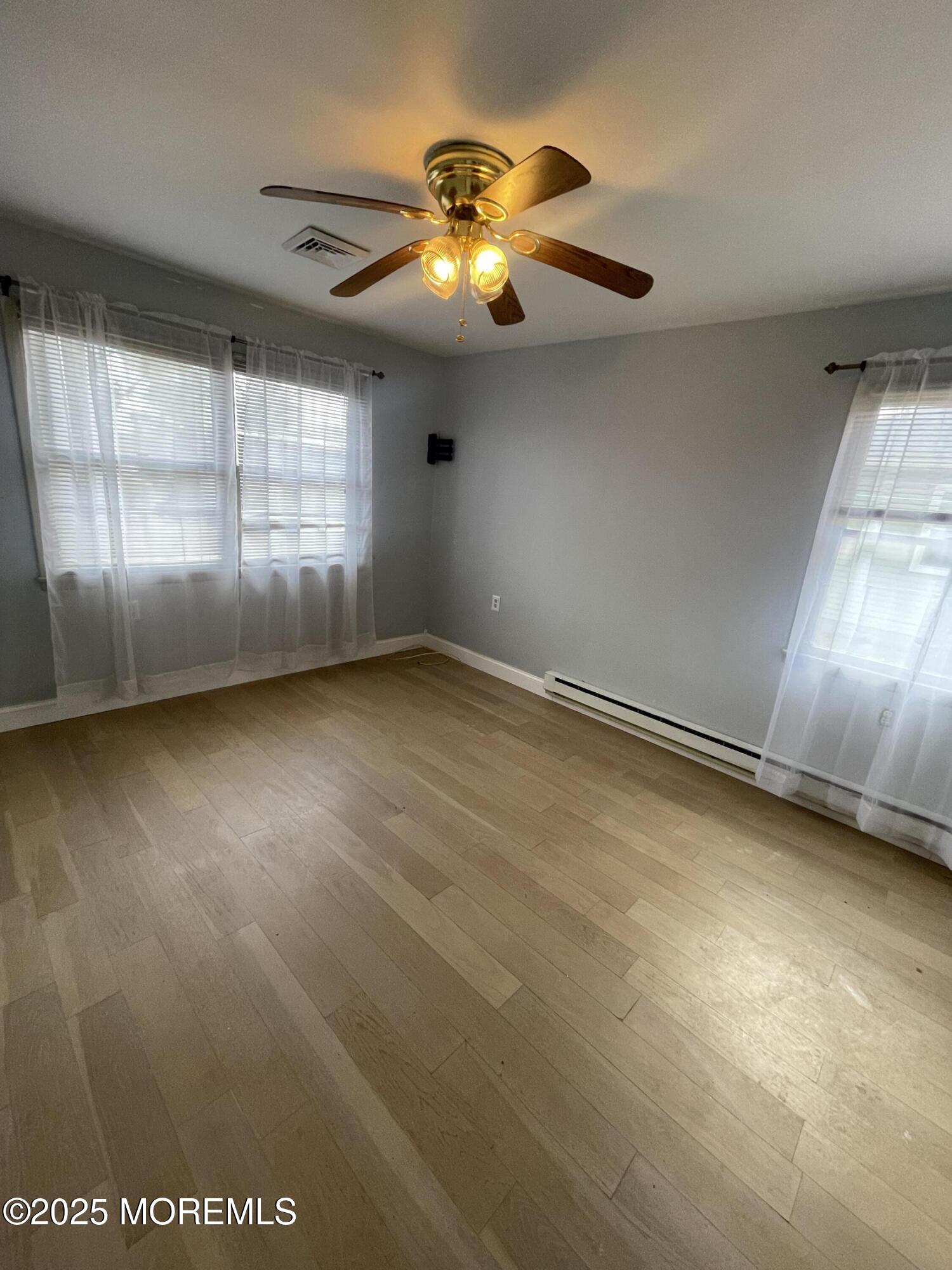 35 Sycamore Access Road, Unit 12 Manahawkin, NJ 08050 - Photo 20 of 34 an empty room with a ceiling fan and window