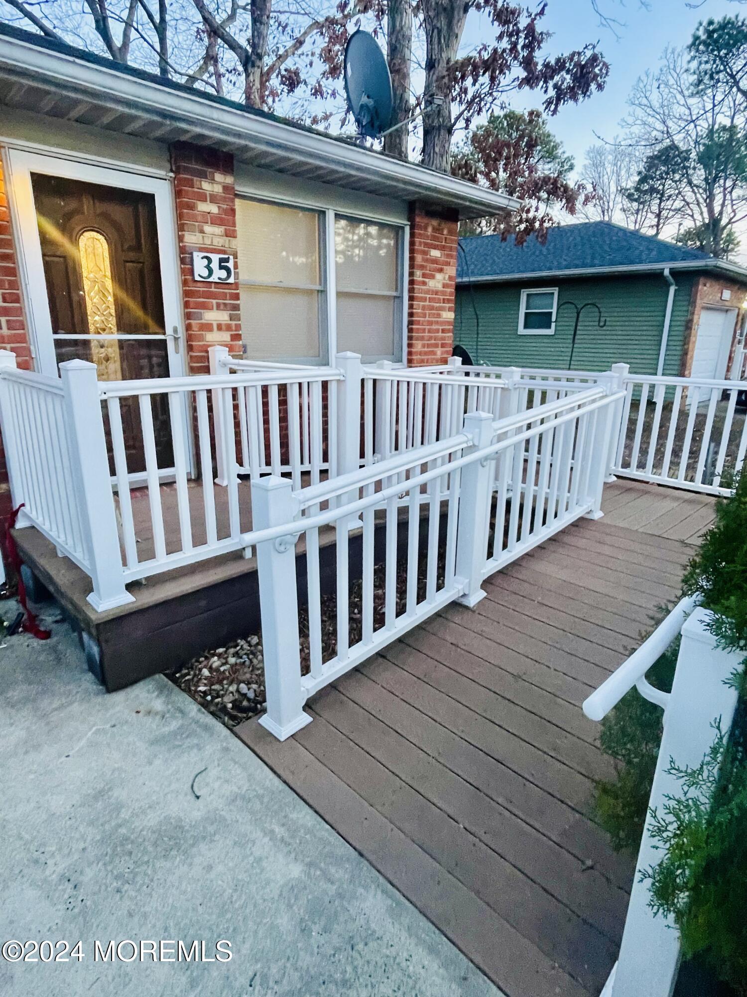 35 Sycamore Access Road, Unit 12 Manahawkin, NJ 08050 - Photo 2 of 34 a view of a house with wooden deck