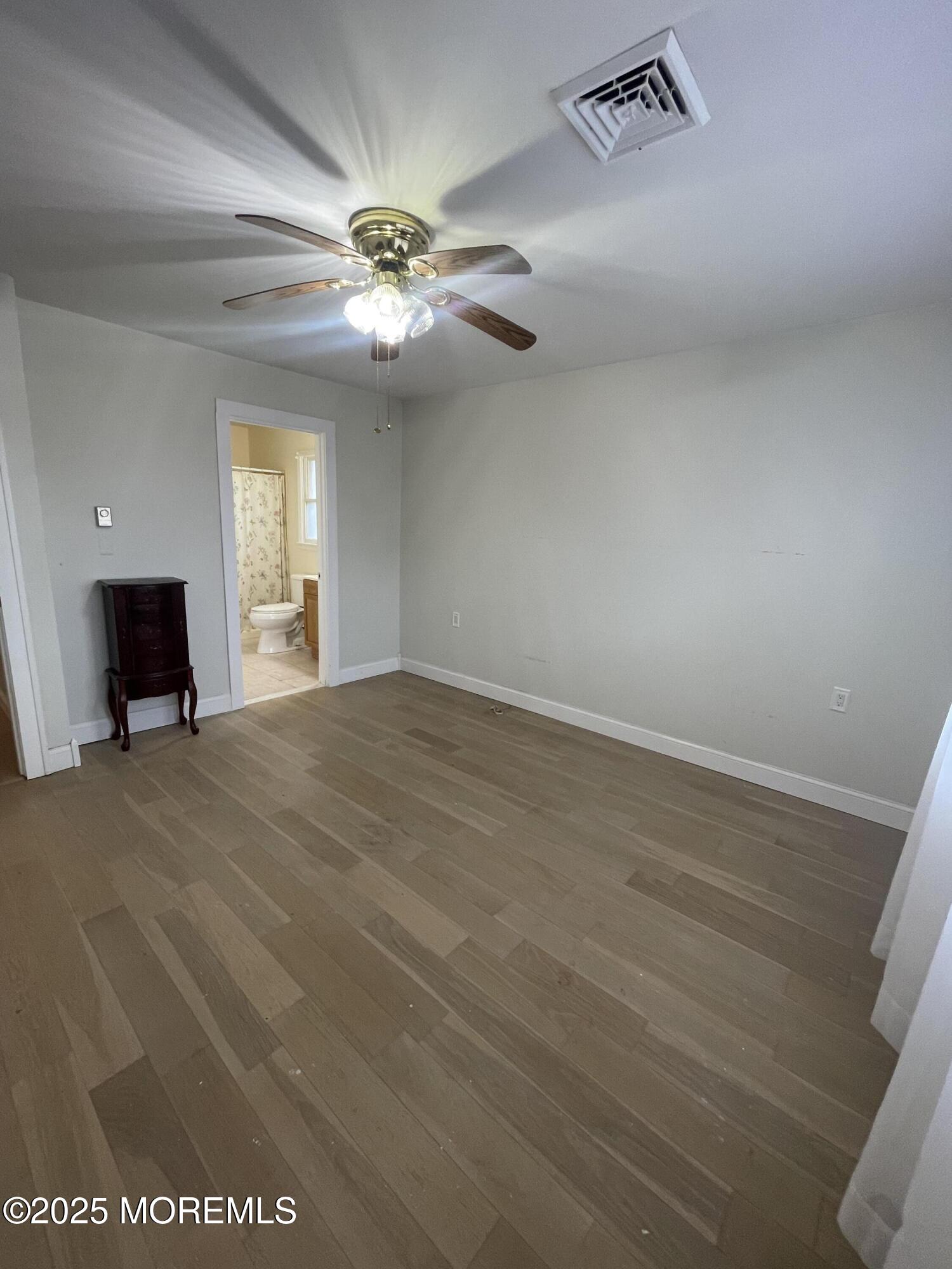 35 Sycamore Access Road, Unit 12 Manahawkin, NJ 08050 - Photo 27 of 34 a view of a livingroom with a ceiling fan and window