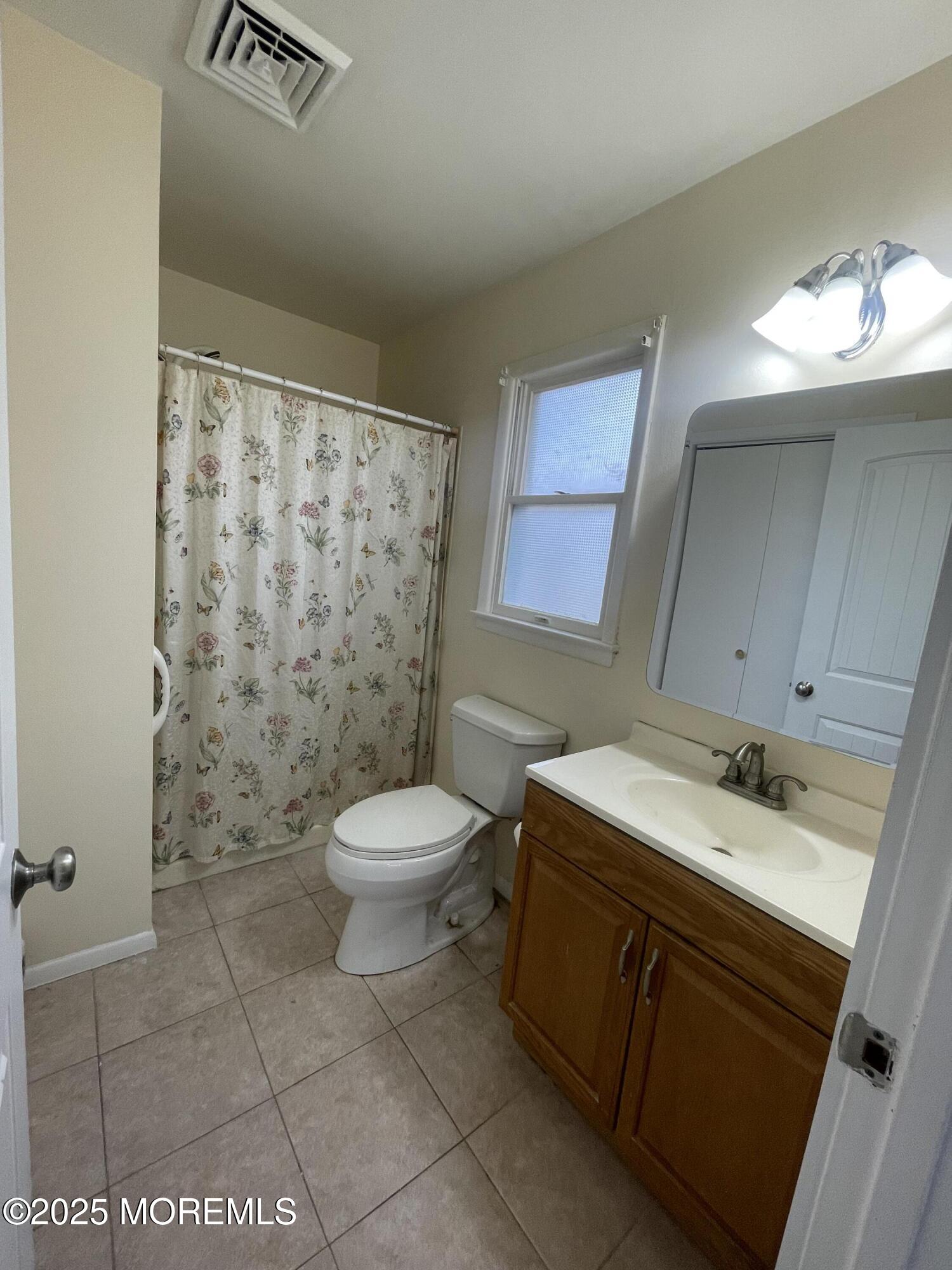 35 Sycamore Access Road, Unit 12 Manahawkin, NJ 08050 - Photo 28 of 34 a bathroom with a sink a toilet and shower