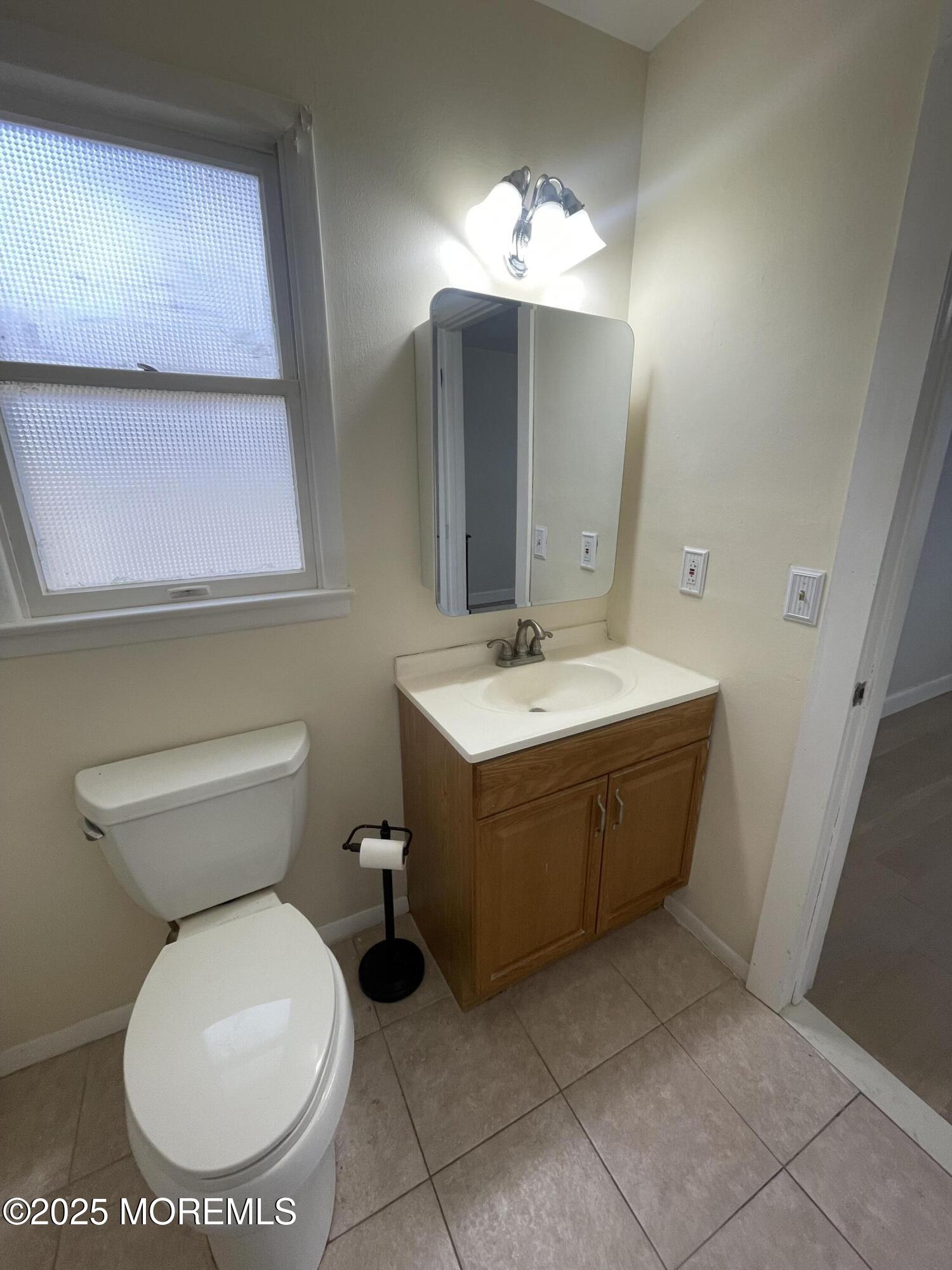 35 Sycamore Access Road, Unit 12 Manahawkin, NJ 08050 - Photo 33 of 34 a bathroom with a sink mirror and toilet