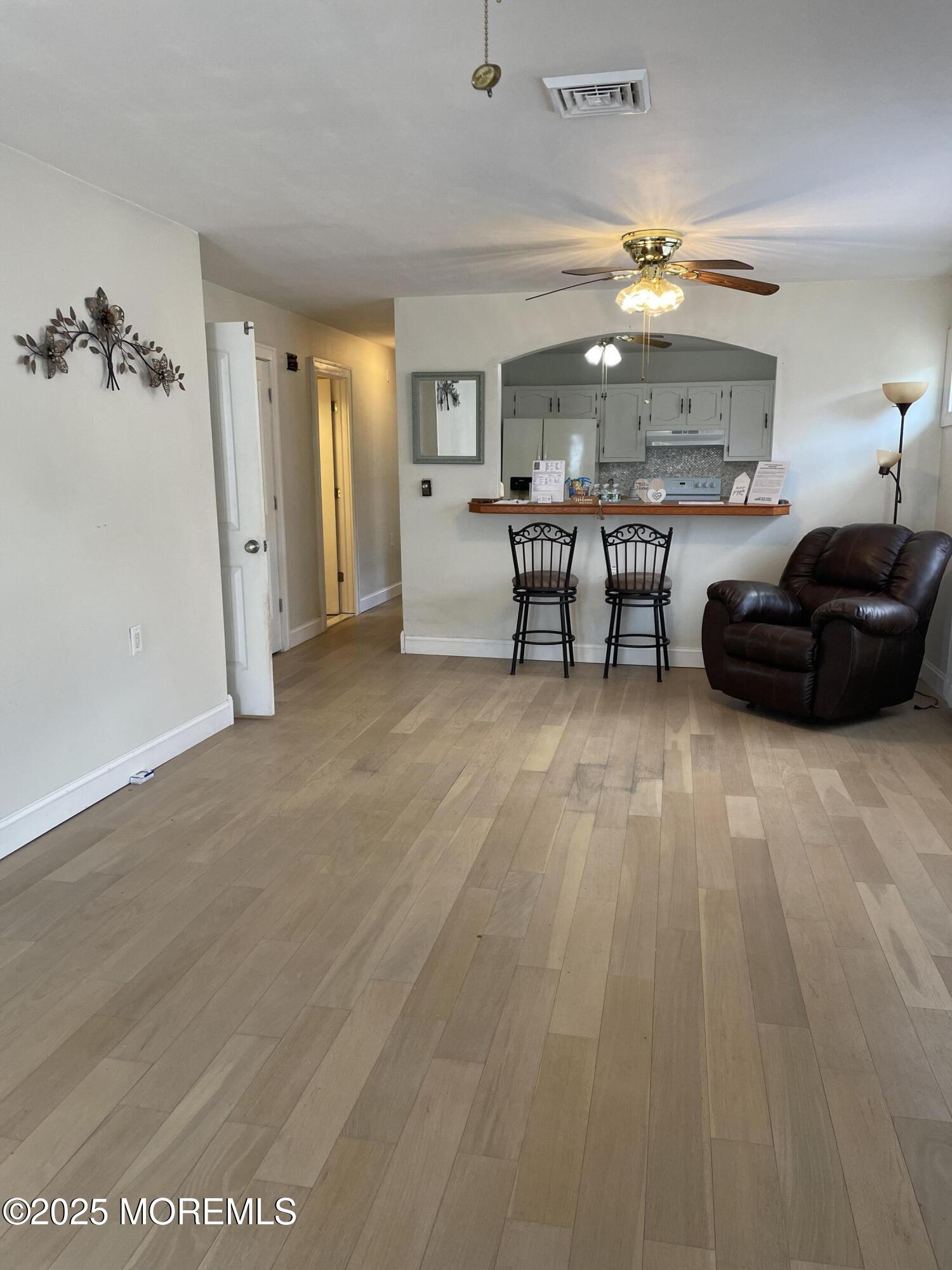 35 Sycamore Access Road, Unit 12 Manahawkin, NJ 08050 - Photo 10 of 34 a living room with furniture and a chandelier