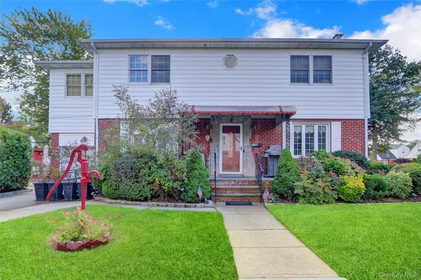 a front view of house with yard and green space