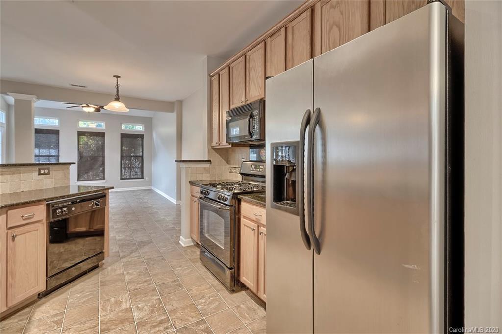 190 Snead Road, Unit 177 Fort Mill, SC 29715 - Photo 11 of 42 a kitchen with stainless steel appliances granite countertop a refrigerator and a stove top oven
