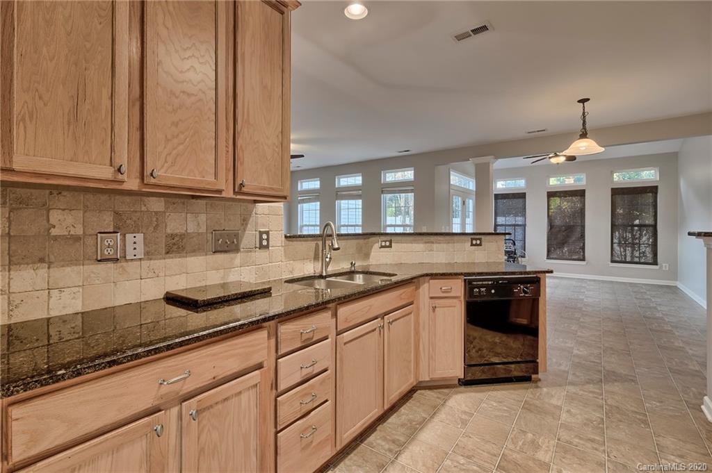 190 Snead Road, Unit 177 Fort Mill, SC 29715 - Photo 12 of 42 a kitchen with stainless steel appliances granite countertop a sink a stove and a wooden floors