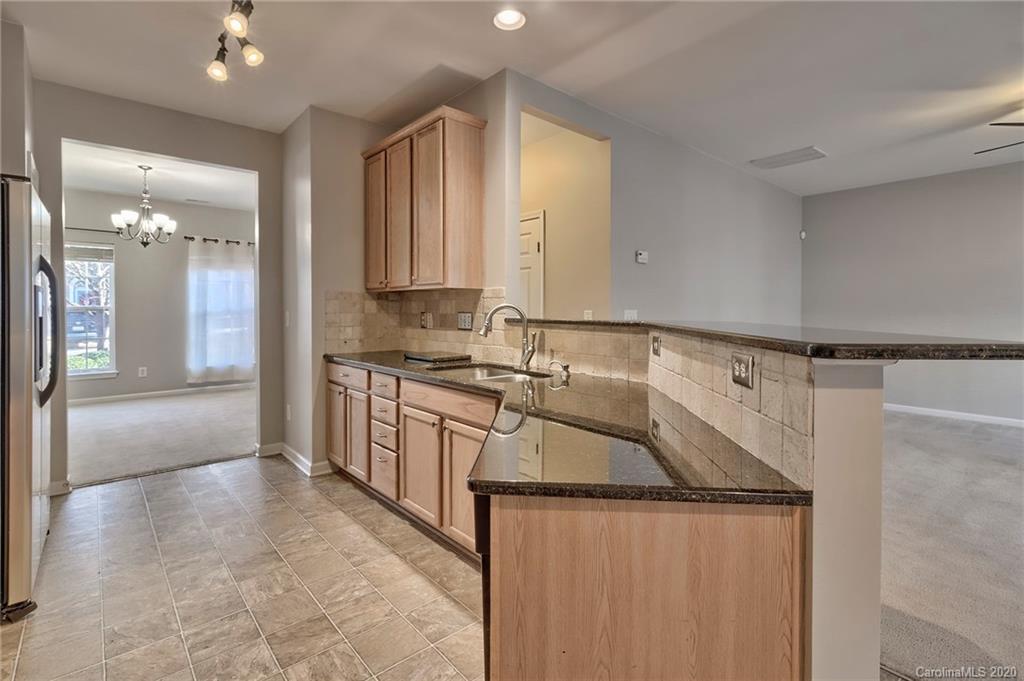 190 Snead Road, Unit 177 Fort Mill, SC 29715 - Photo 13 of 42 a kitchen with stainless steel appliances granite countertop a sink a stove and a refrigerator
