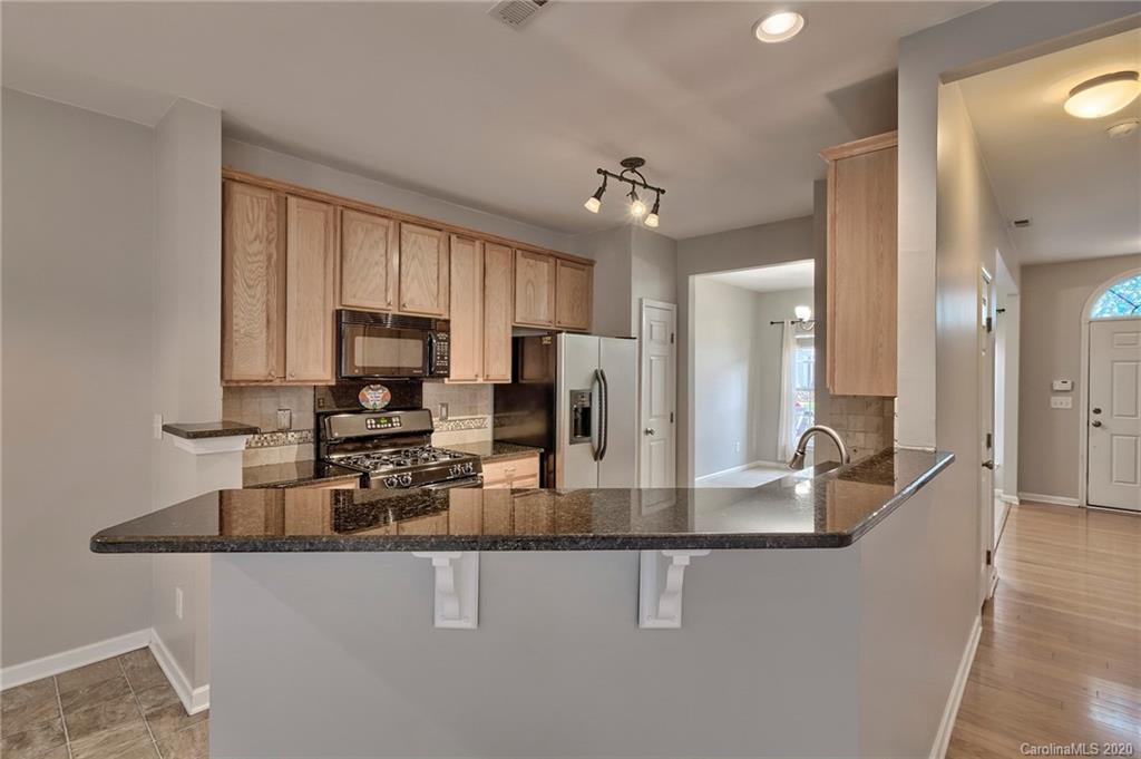 190 Snead Road, Unit 177 Fort Mill, SC 29715 - Photo 14 of 42 a kitchen with kitchen island granite countertop a sink and refrigerator