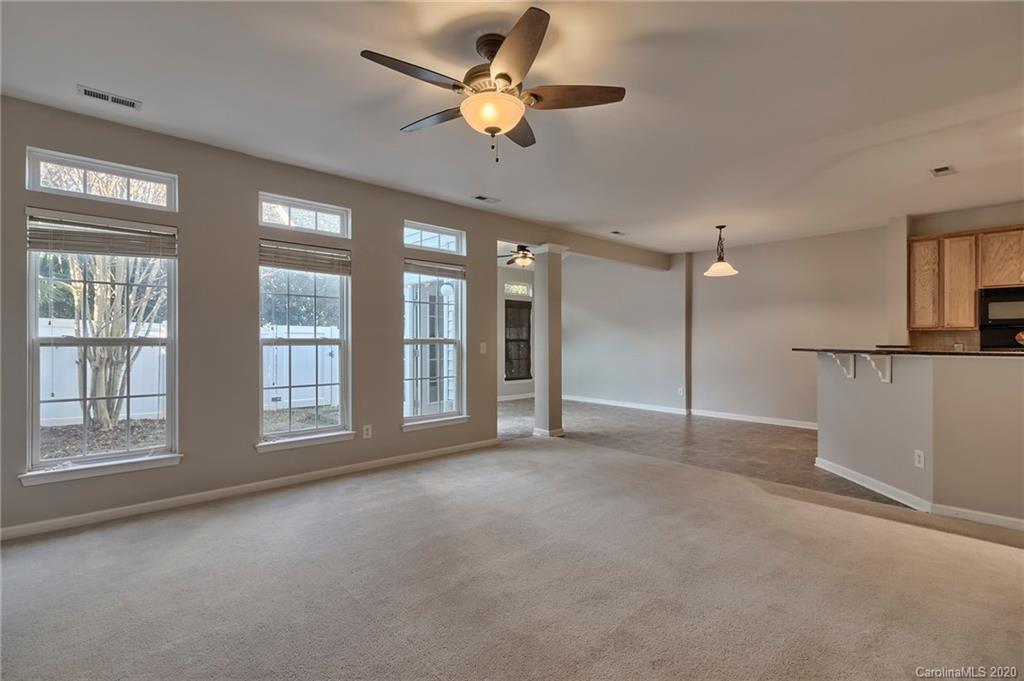 190 Snead Road, Unit 177 Fort Mill, SC 29715 - Photo 22 of 42 a view of an empty room with a window and a kitchen
