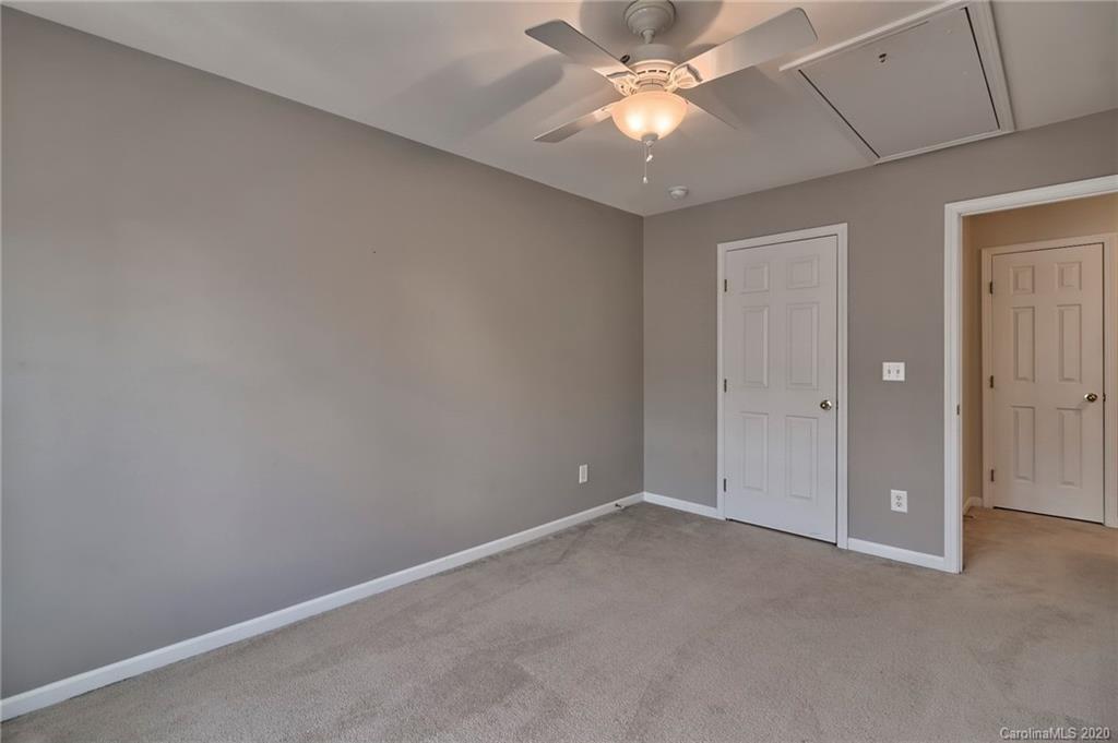 190 Snead Road, Unit 177 Fort Mill, SC 29715 - Photo 26 of 42 an empty room with a chandelier fan and a ceiling fan