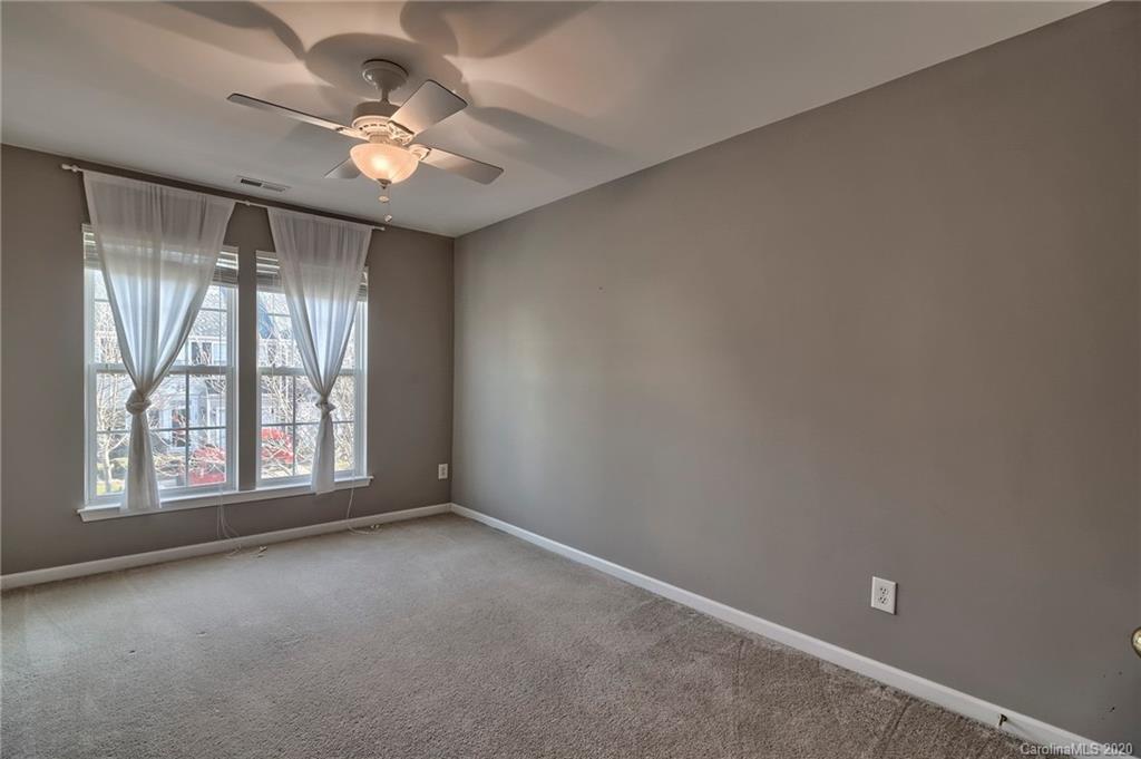 190 Snead Road, Unit 177 Fort Mill, SC 29715 - Photo 27 of 42 an empty room with windows and chandelier fan