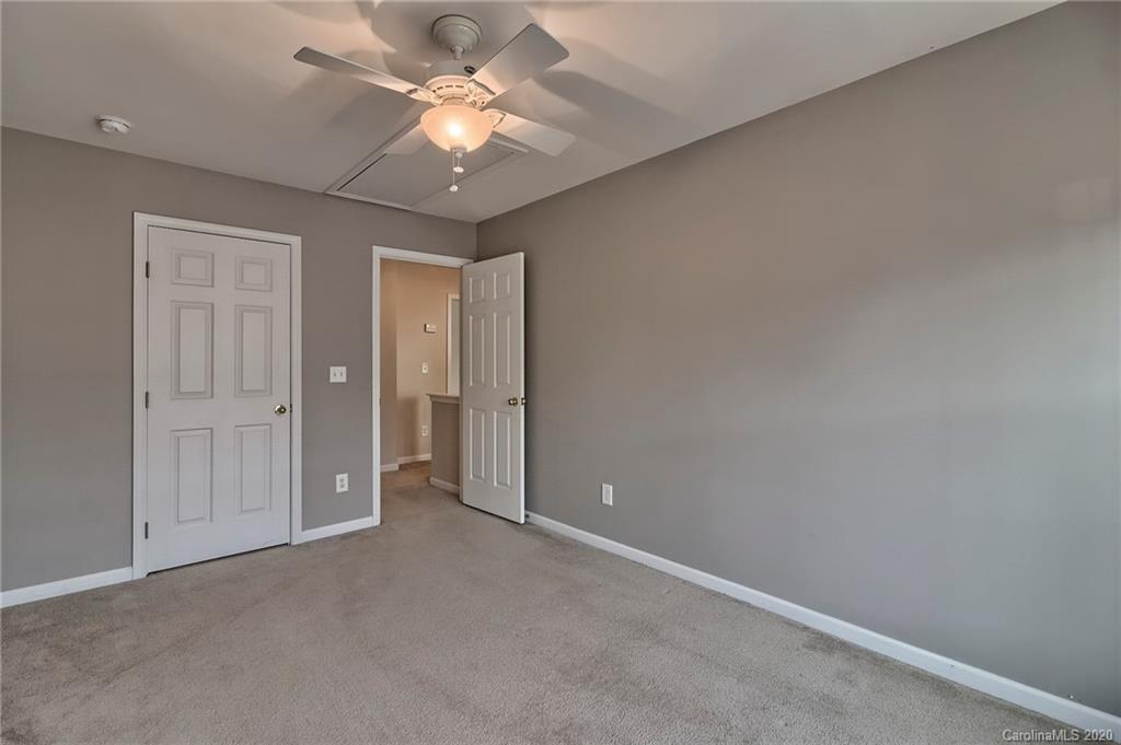 190 Snead Road, Unit 177 Fort Mill, SC 29715 - Photo 29 of 42 an empty room with a chandelier fan and a ceiling fan