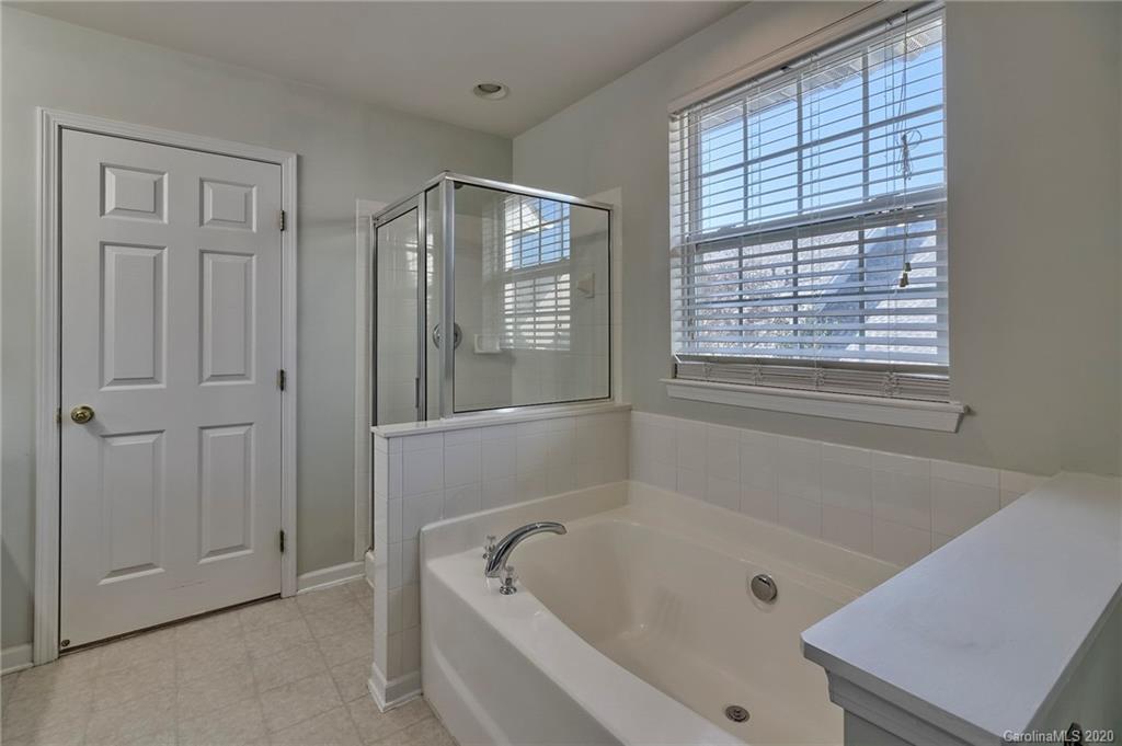 190 Snead Road, Unit 177 Fort Mill, SC 29715 - Photo 31 of 42 a white bath tub sitting in a bathroom next to a window