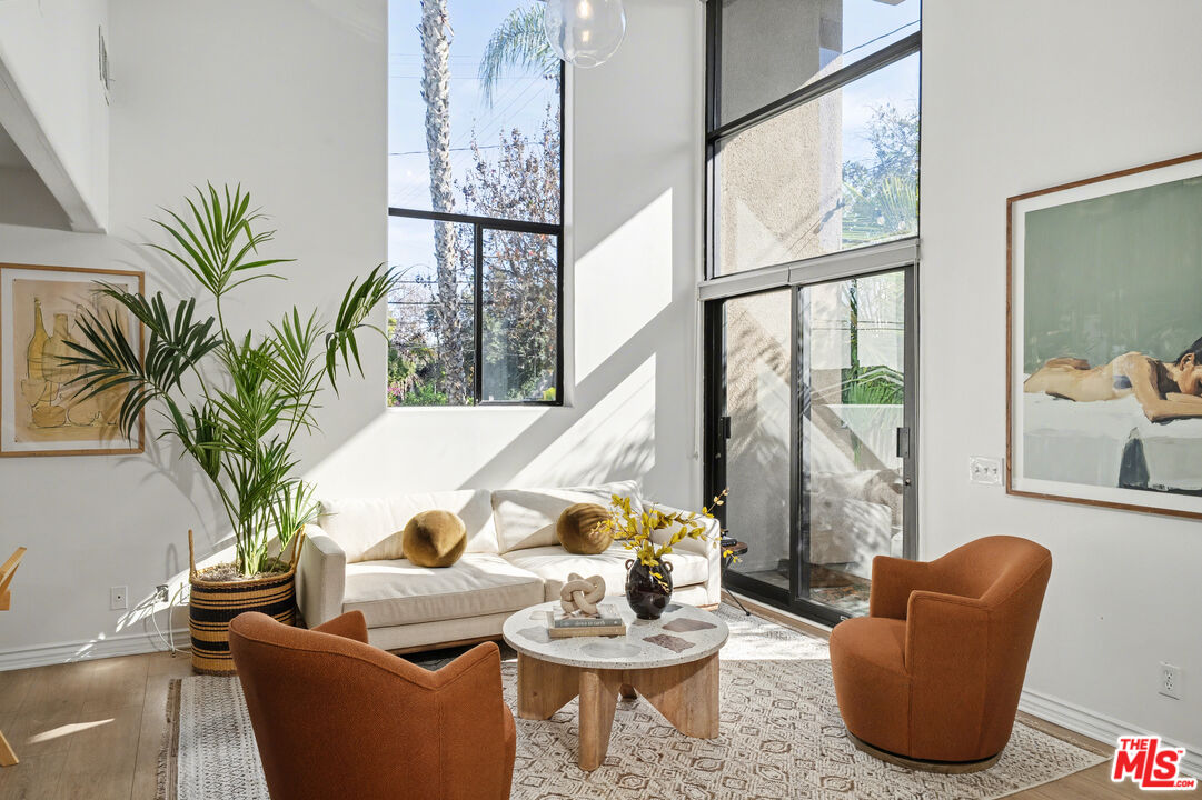 9917 Tabor Street, Unit 2 Los Angeles, CA 90034 - Photo 14 of 38 a living room with furniture and a potted plant