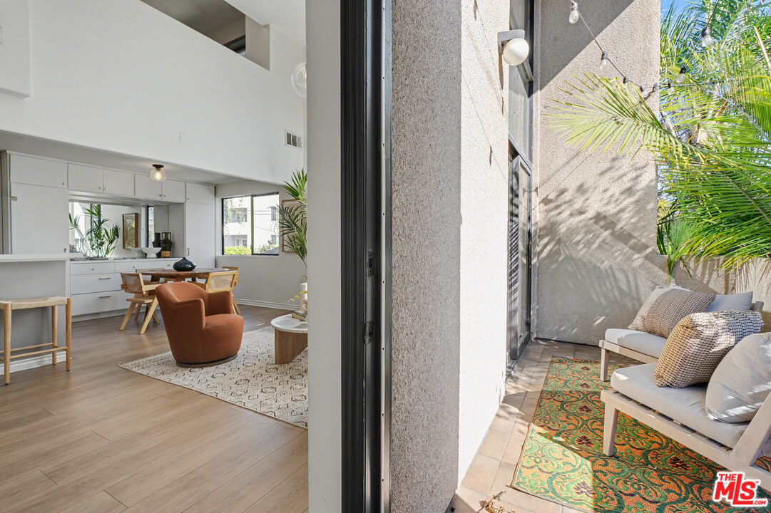 9917 Tabor Street, Unit 2 Los Angeles, CA 90034 - Photo 15 of 38 a living room with furniture and a potted plant