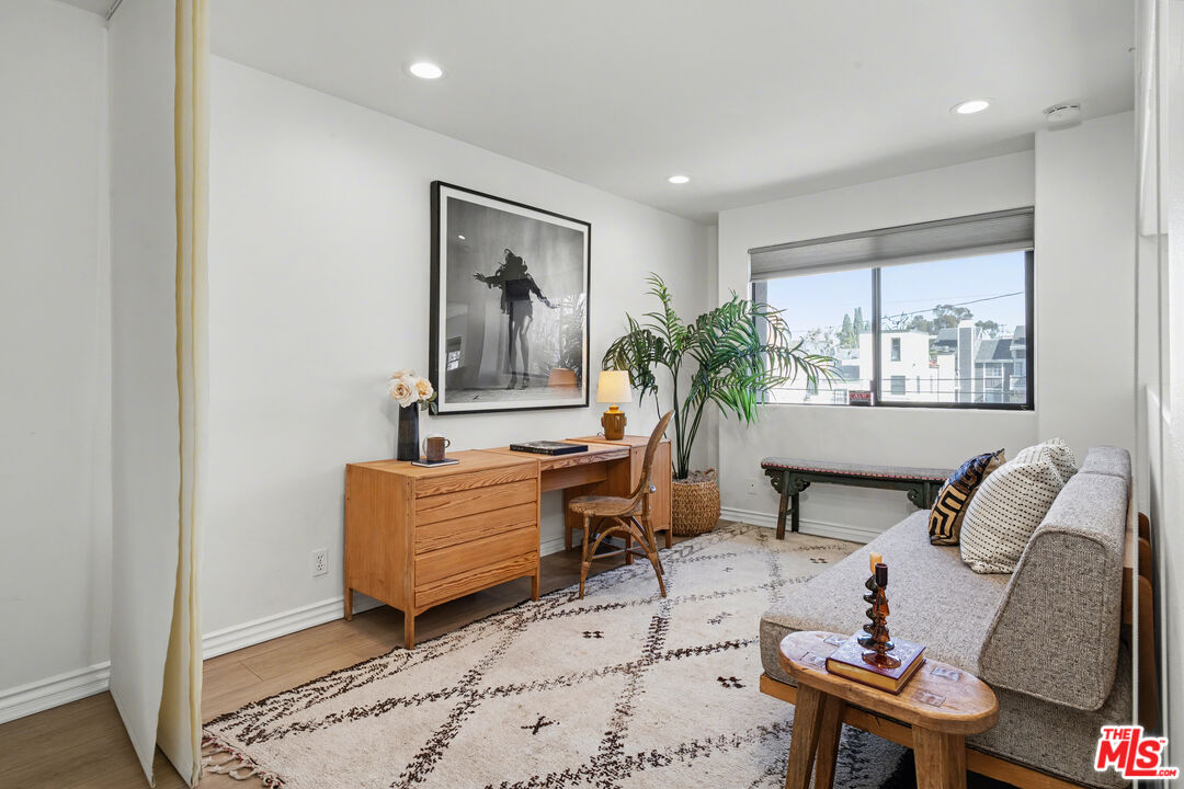 9917 Tabor Street, Unit 2 Los Angeles, CA 90034 - Photo 20 of 38 a living room with furniture and a painting on the wall