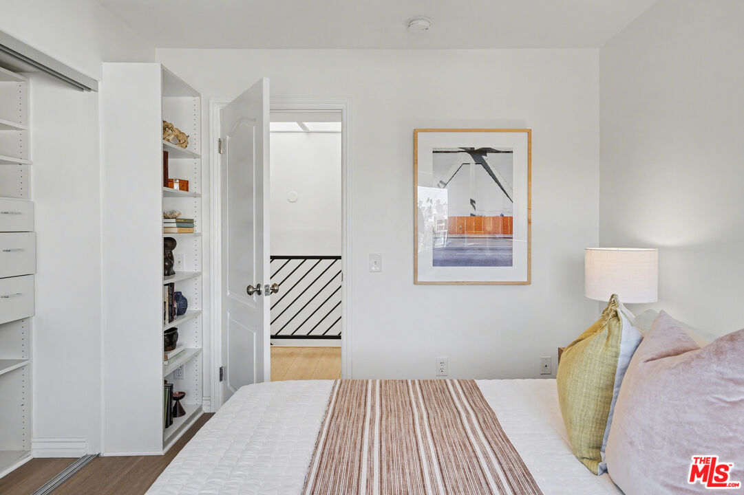 9917 Tabor Street, Unit 2 Los Angeles, CA 90034 - Photo 29 of 38 a view of a bedroom with wooden floor and bed